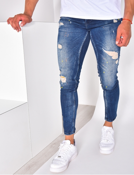 Men's ripped jeans with paint flecks